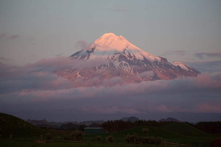 Le Taranaki au sommet enneigé dans les nuages